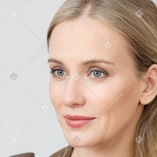 Joyful white young-adult female with long  brown hair and blue eyes