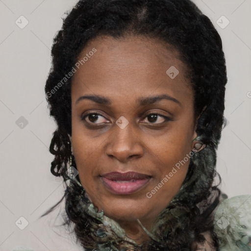 Joyful black young-adult female with long  black hair and brown eyes