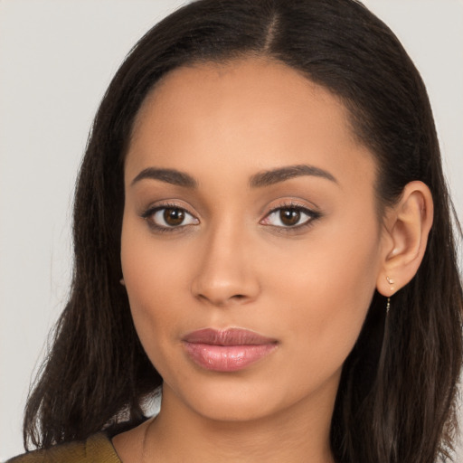 Joyful latino young-adult female with long  brown hair and brown eyes