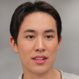 Joyful asian young-adult male with short  brown hair and brown eyes