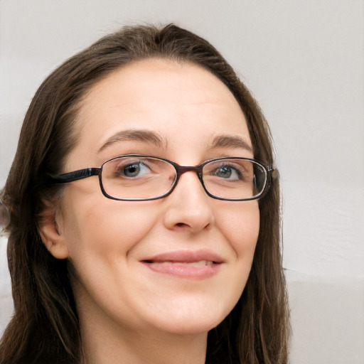 Joyful white adult female with long  brown hair and brown eyes