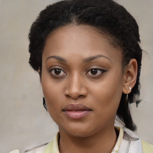 Joyful black young-adult female with medium  brown hair and brown eyes