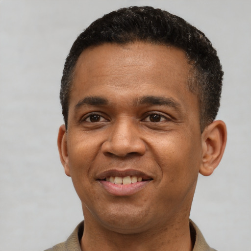 Joyful latino young-adult male with short  black hair and brown eyes