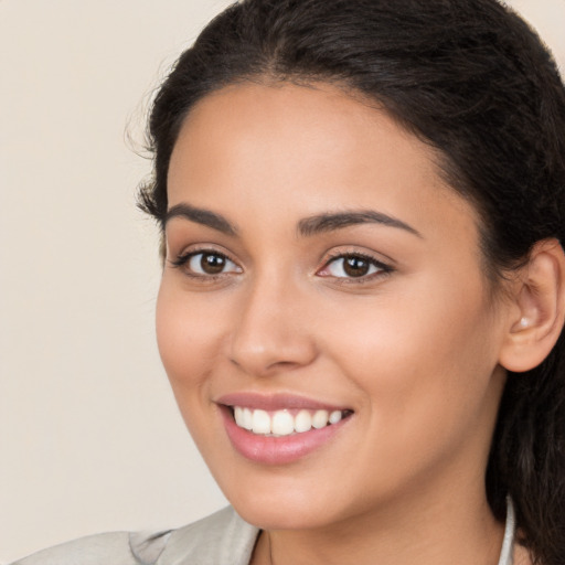 Joyful white young-adult female with long  brown hair and brown eyes