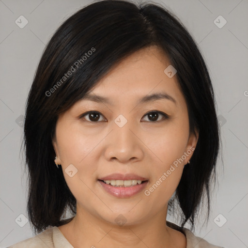 Joyful asian young-adult female with medium  black hair and brown eyes