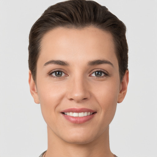 Joyful white young-adult female with short  brown hair and brown eyes