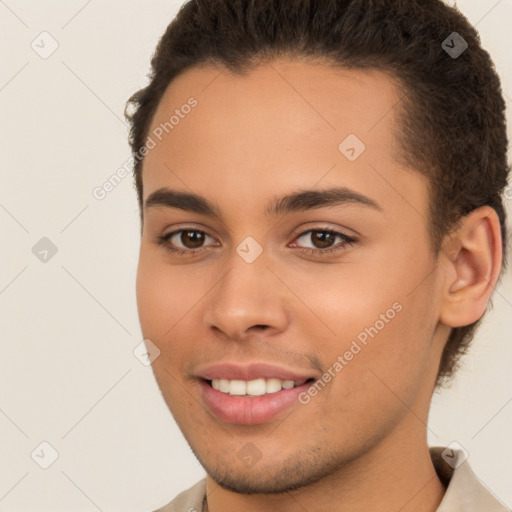 Joyful white young-adult male with short  brown hair and brown eyes