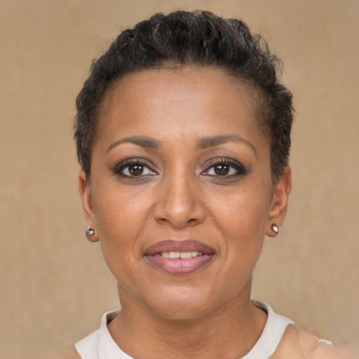 Joyful black adult female with short  brown hair and brown eyes