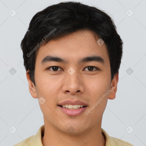 Joyful asian young-adult male with short  black hair and brown eyes