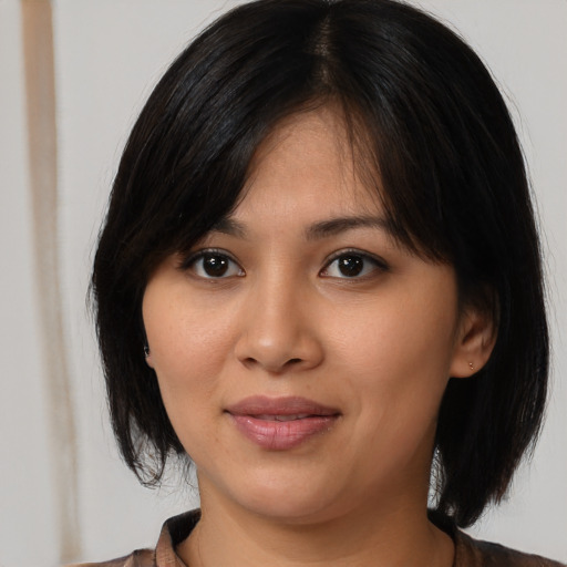 Joyful asian young-adult female with medium  black hair and brown eyes