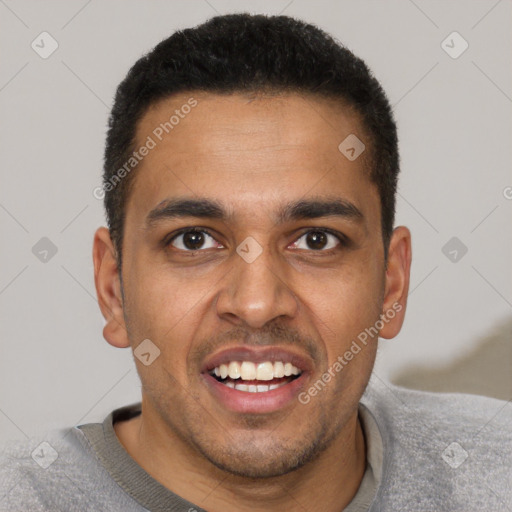 Joyful black young-adult male with short  brown hair and brown eyes