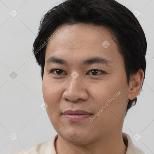 Joyful asian young-adult male with short  black hair and brown eyes