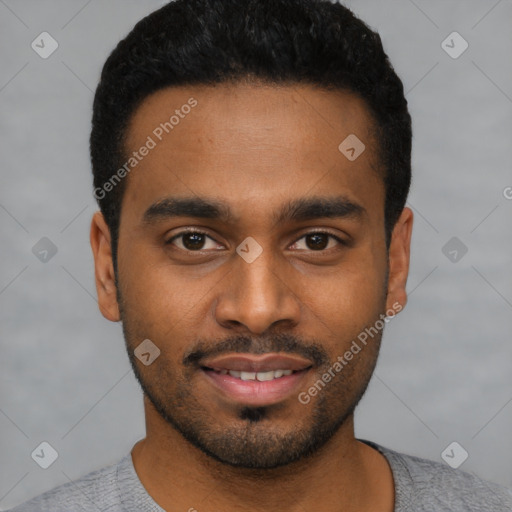 Joyful black young-adult male with short  black hair and brown eyes