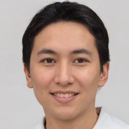 Joyful asian young-adult male with short  brown hair and brown eyes