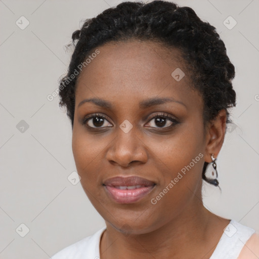 Joyful black young-adult female with short  black hair and brown eyes