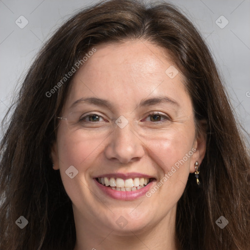 Joyful white adult female with long  brown hair and grey eyes