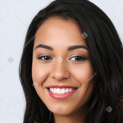 Joyful latino young-adult female with long  black hair and brown eyes