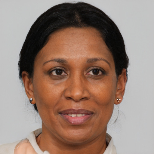 Joyful black adult female with medium  black hair and brown eyes
