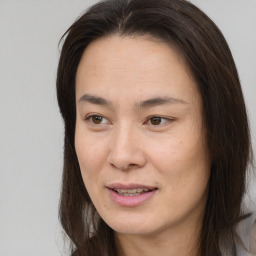 Joyful asian young-adult female with long  brown hair and brown eyes