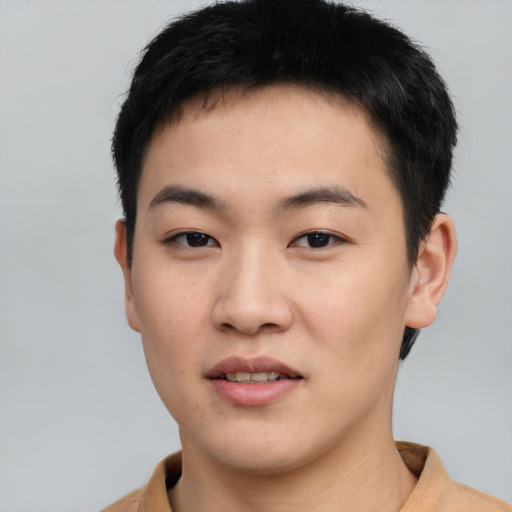 Joyful asian young-adult male with short  black hair and brown eyes