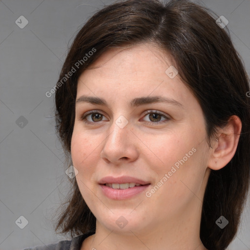 Joyful white young-adult female with medium  brown hair and grey eyes