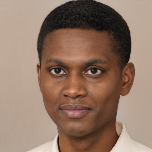 Joyful black young-adult male with short  brown hair and brown eyes