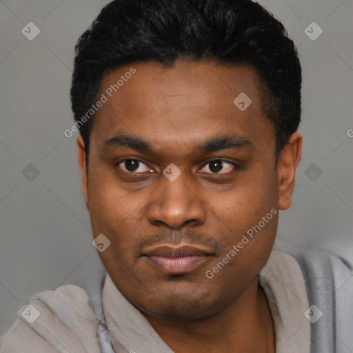 Joyful black young-adult male with short  black hair and brown eyes