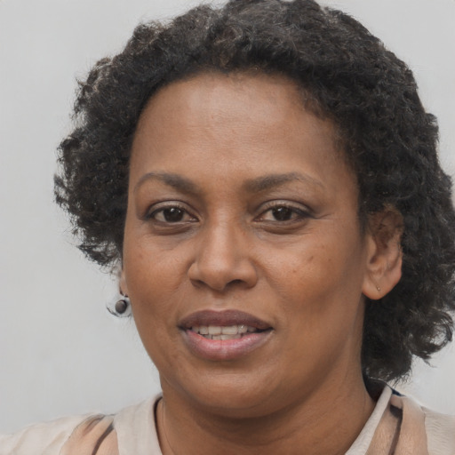Joyful black adult female with short  brown hair and brown eyes