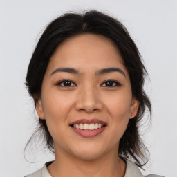 Joyful asian young-adult female with medium  brown hair and brown eyes