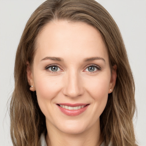 Joyful white young-adult female with long  brown hair and grey eyes