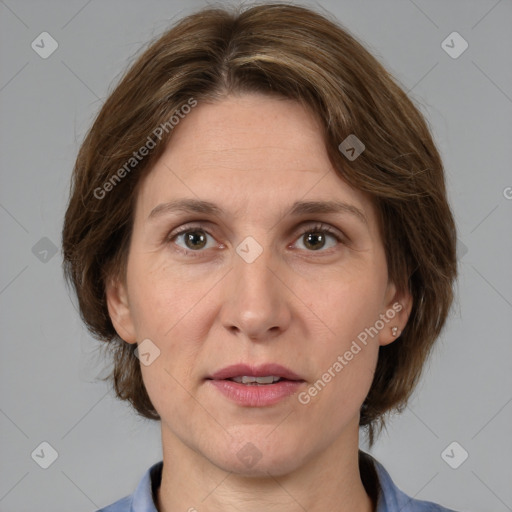 Joyful white adult female with medium  brown hair and grey eyes