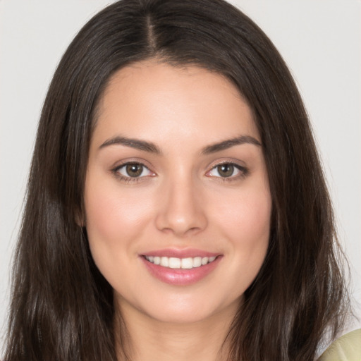 Joyful white young-adult female with long  brown hair and brown eyes