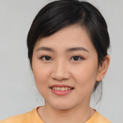 Joyful asian young-adult female with medium  brown hair and brown eyes