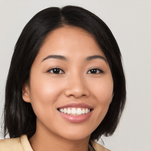 Joyful latino young-adult female with long  brown hair and brown eyes