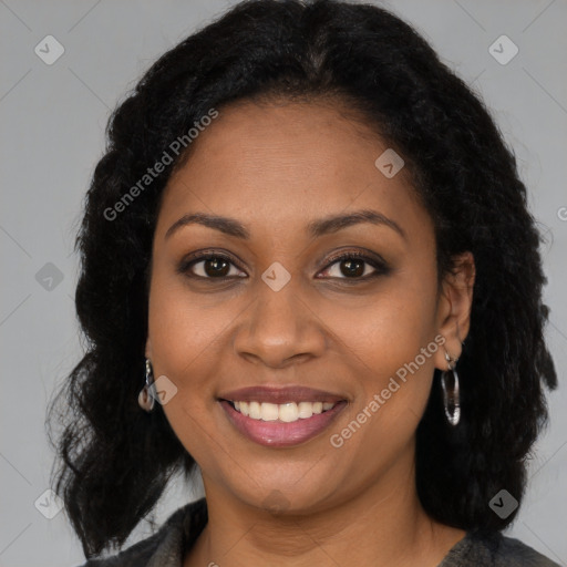 Joyful black young-adult female with long  brown hair and brown eyes