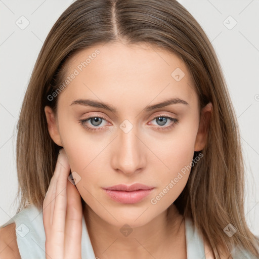 Neutral white young-adult female with long  brown hair and brown eyes