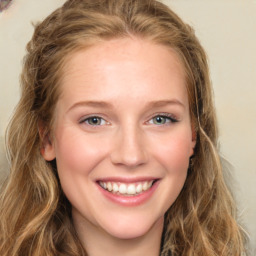 Joyful white young-adult female with long  brown hair and green eyes