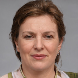 Joyful white adult female with medium  brown hair and blue eyes