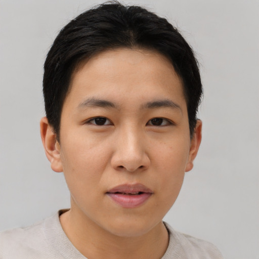 Joyful asian young-adult female with short  brown hair and brown eyes