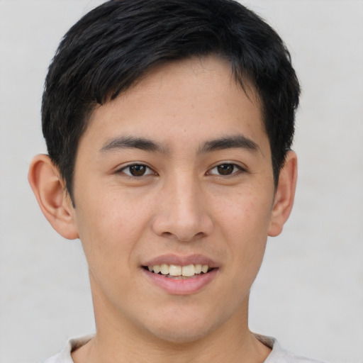 Joyful asian young-adult male with short  brown hair and brown eyes