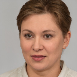 Joyful white adult female with short  brown hair and grey eyes