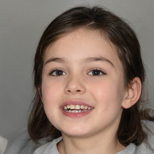 Joyful white child female with medium  brown hair and brown eyes