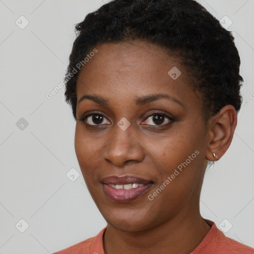 Joyful black young-adult female with short  black hair and brown eyes