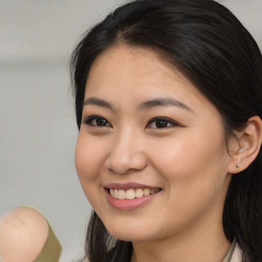 Joyful white young-adult female with medium  brown hair and brown eyes