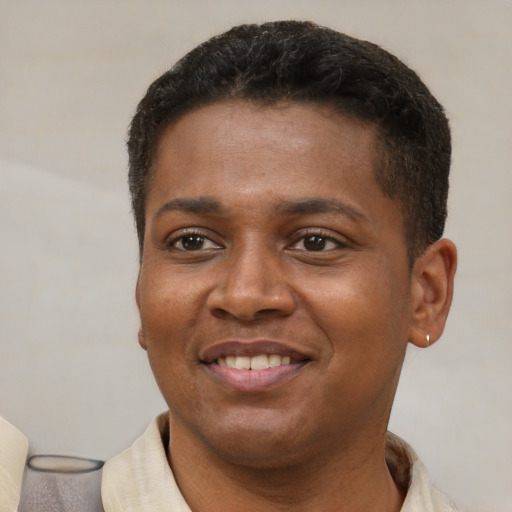 Joyful latino young-adult male with short  brown hair and brown eyes