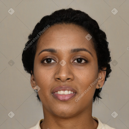 Joyful black young-adult female with short  black hair and brown eyes