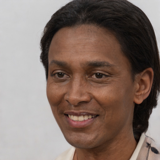 Joyful black adult male with short  brown hair and brown eyes