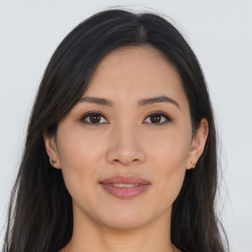 Joyful asian young-adult female with long  brown hair and brown eyes