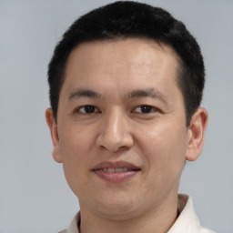 Joyful white adult male with short  black hair and brown eyes