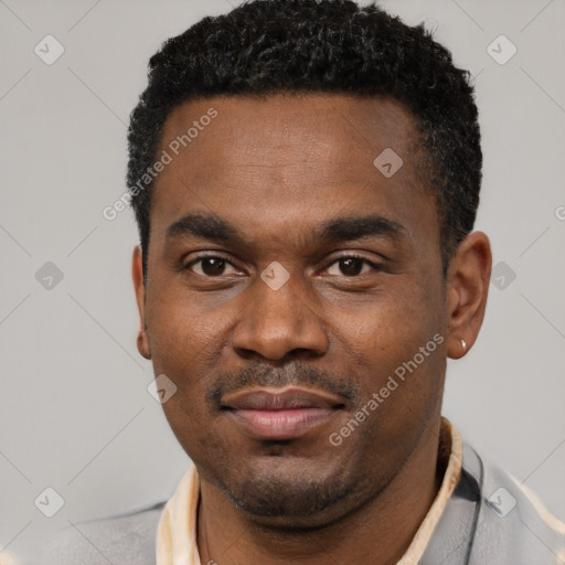 Joyful black young-adult male with short  black hair and brown eyes